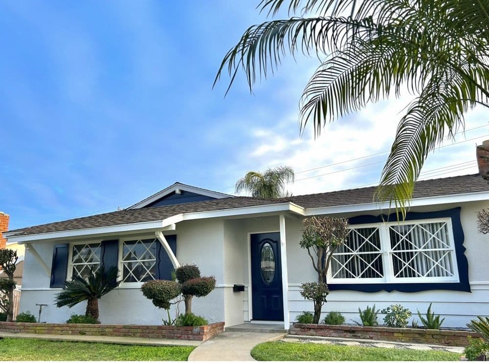 Exterior repaint, white house with navy door
