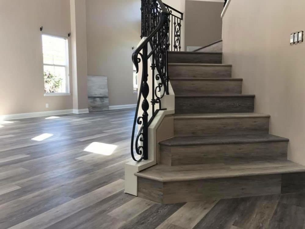 Grey vinyl plank flooring and stairs